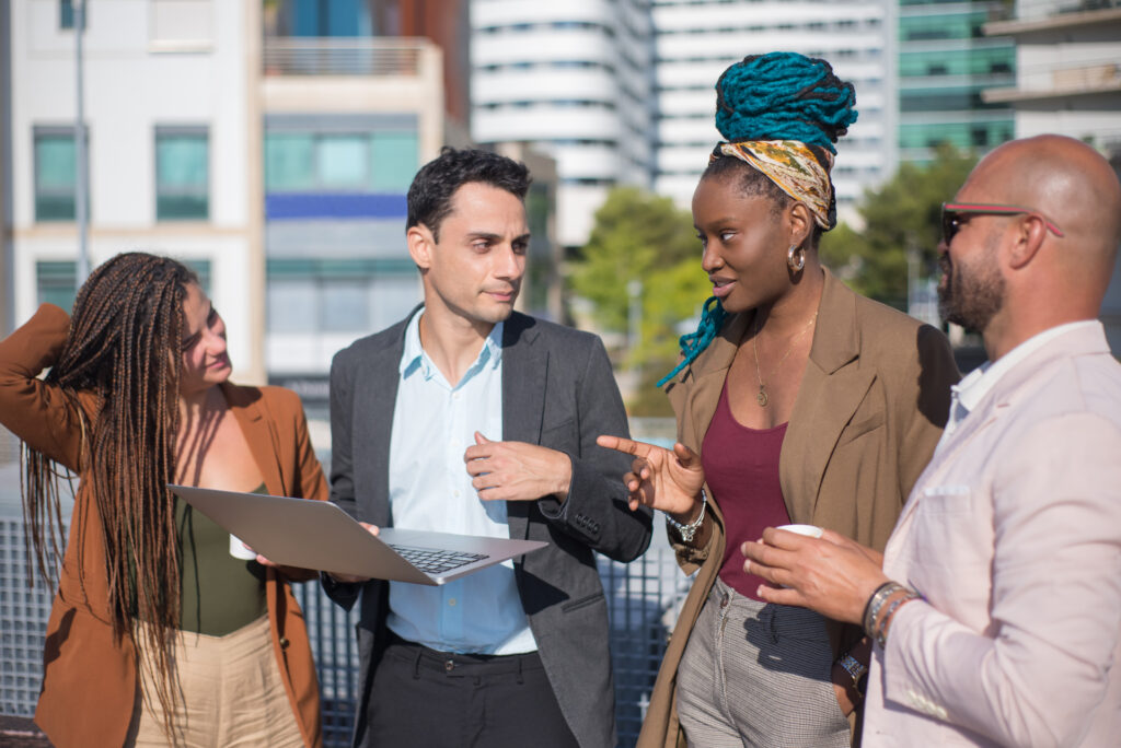 Smart-dressed business people discussing matters on terrace roof